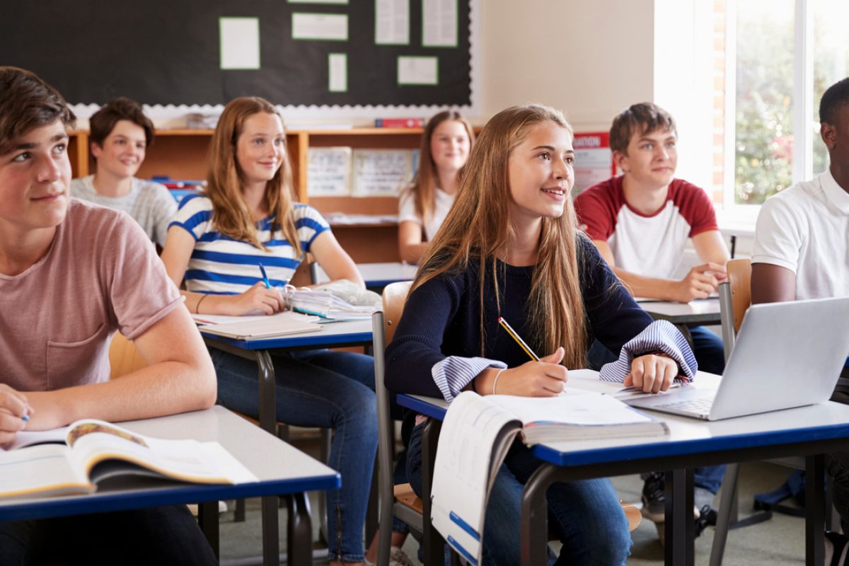 Students,Listening,To,Female,Teacher,In,Classroom